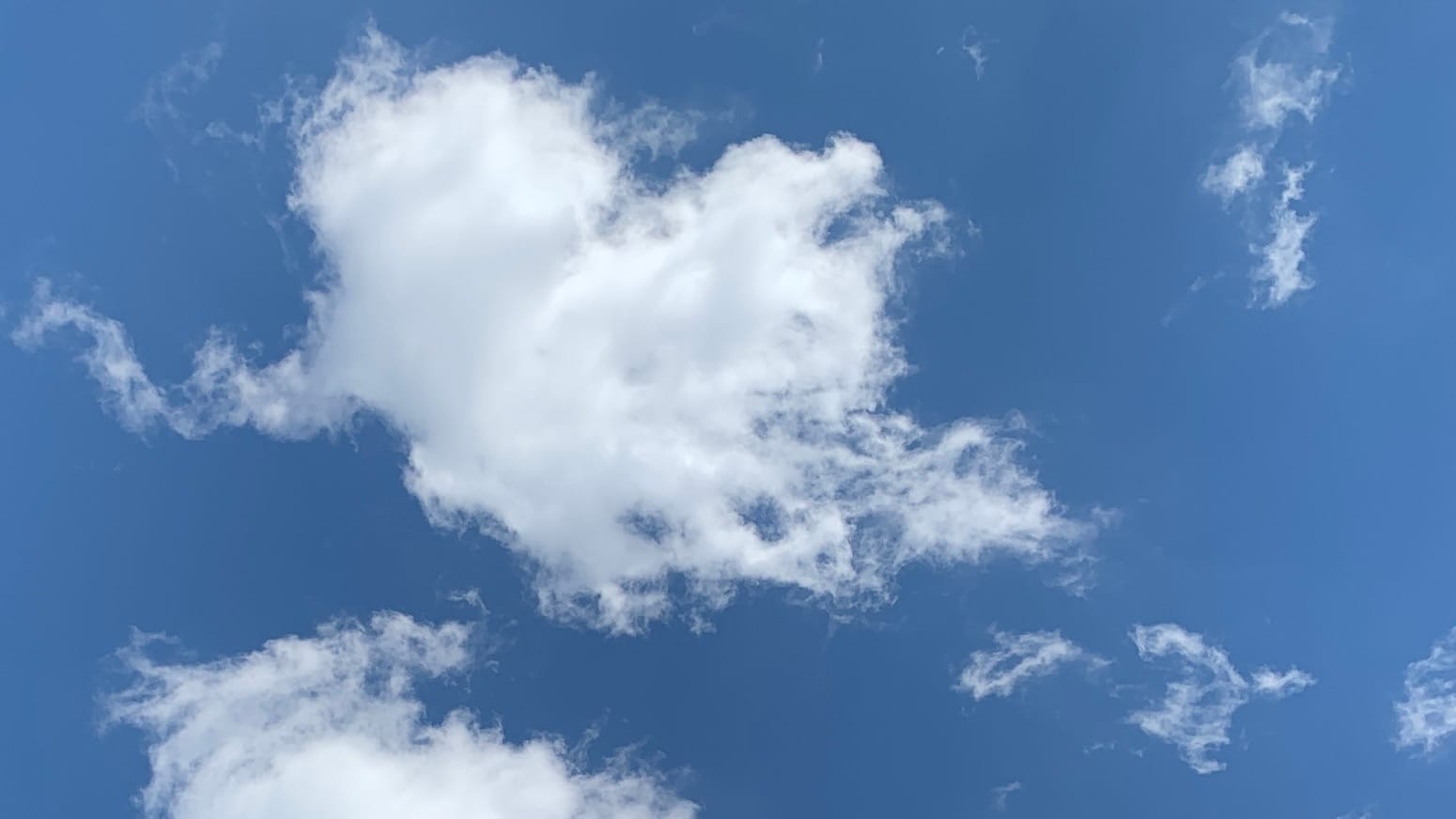 Wispy puffy cloud in lovely blue