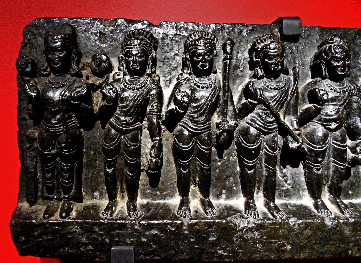 Figures carved into shiny black rock