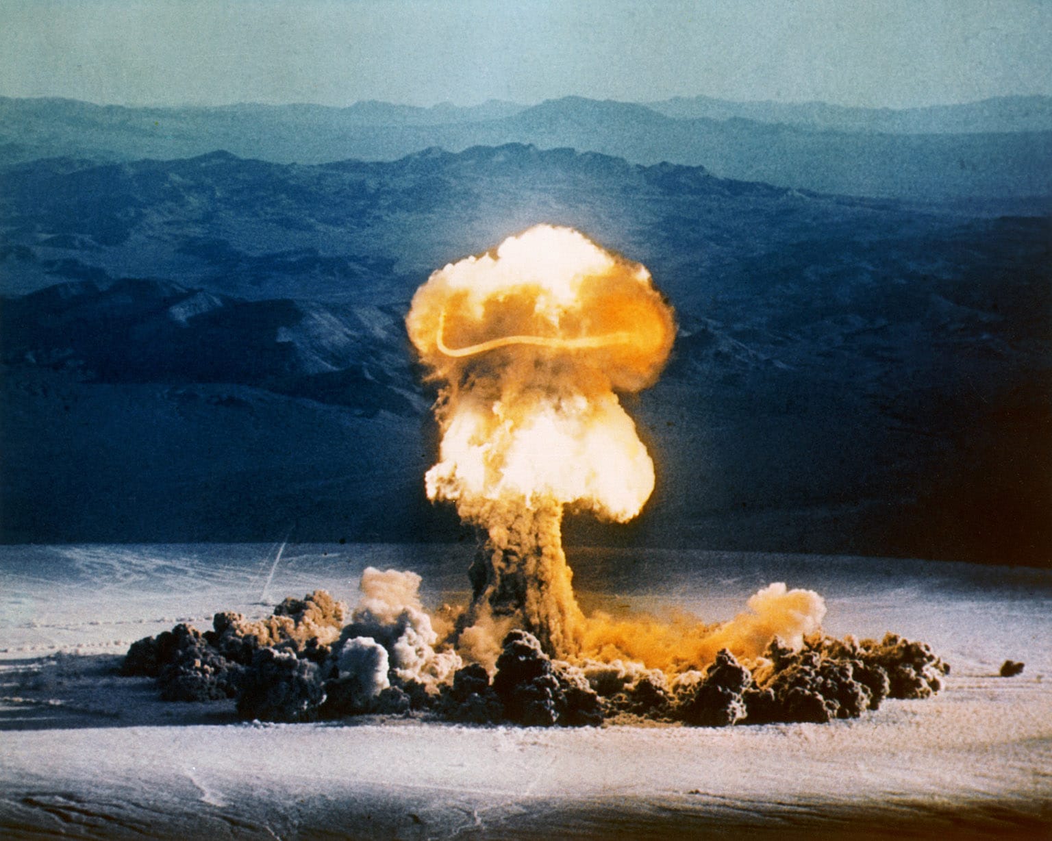 Full-color photo of the 37 kt KABOOM on the flat desert with mountains in background