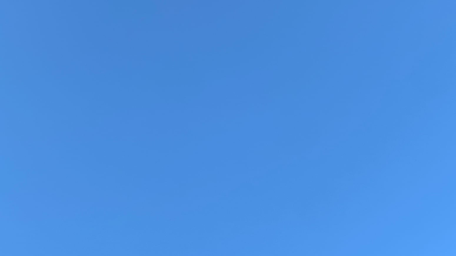 A patch of clear medium-deep-blue sky