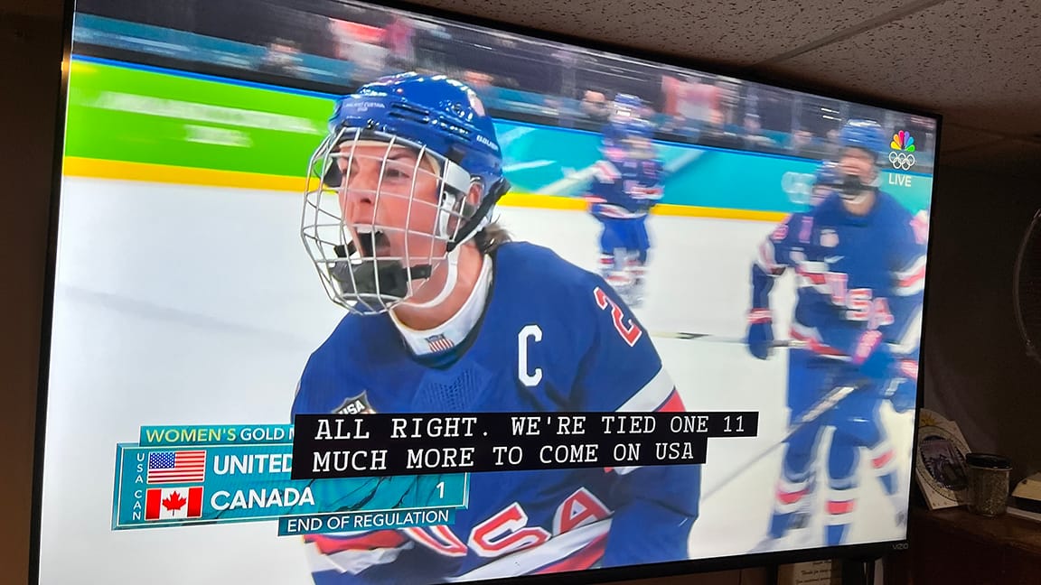Captain of the U.S. hockey players screaming after they tied it up. On screen: END OF REGULATION - CC: ALL RIGHT WE'RE TIED ONE-ONE MUCH MORE TO COME