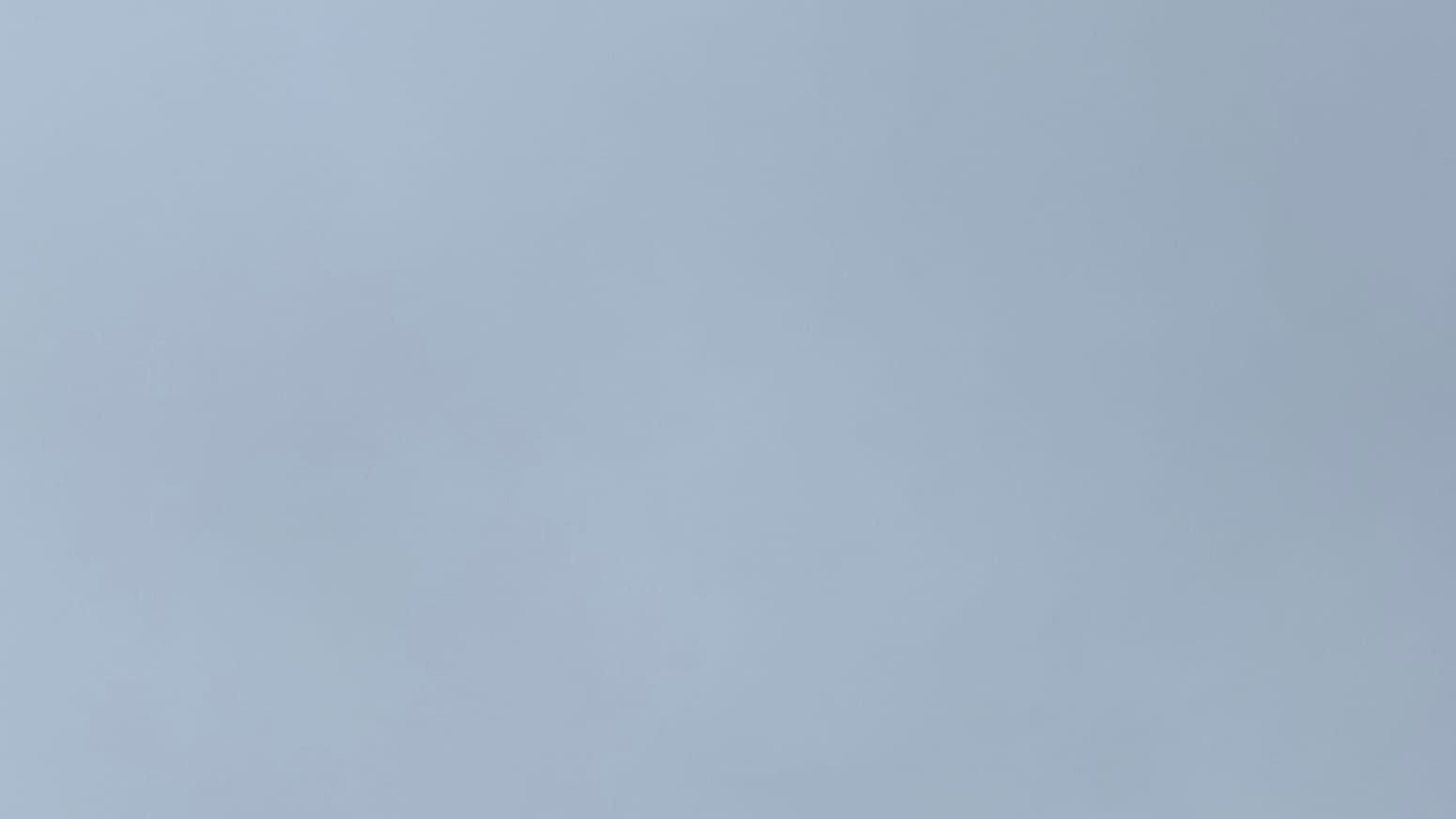 A patch of dull gray sky with the tiniest undertones of something like teal blue