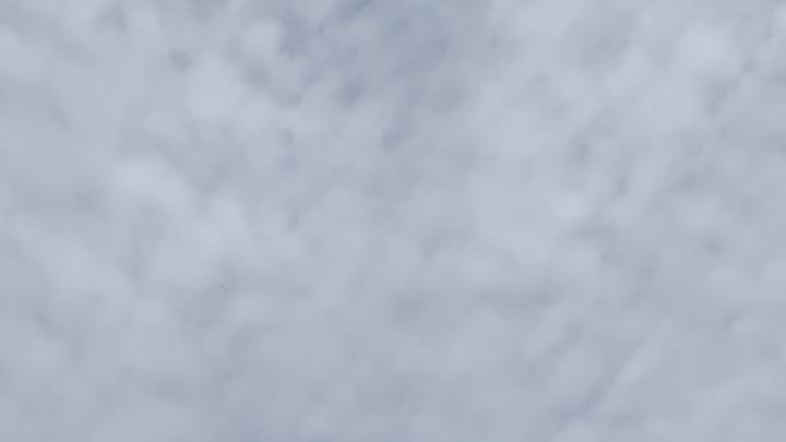 A patch of medium-gray cloudy sky mottled with darker gray. 