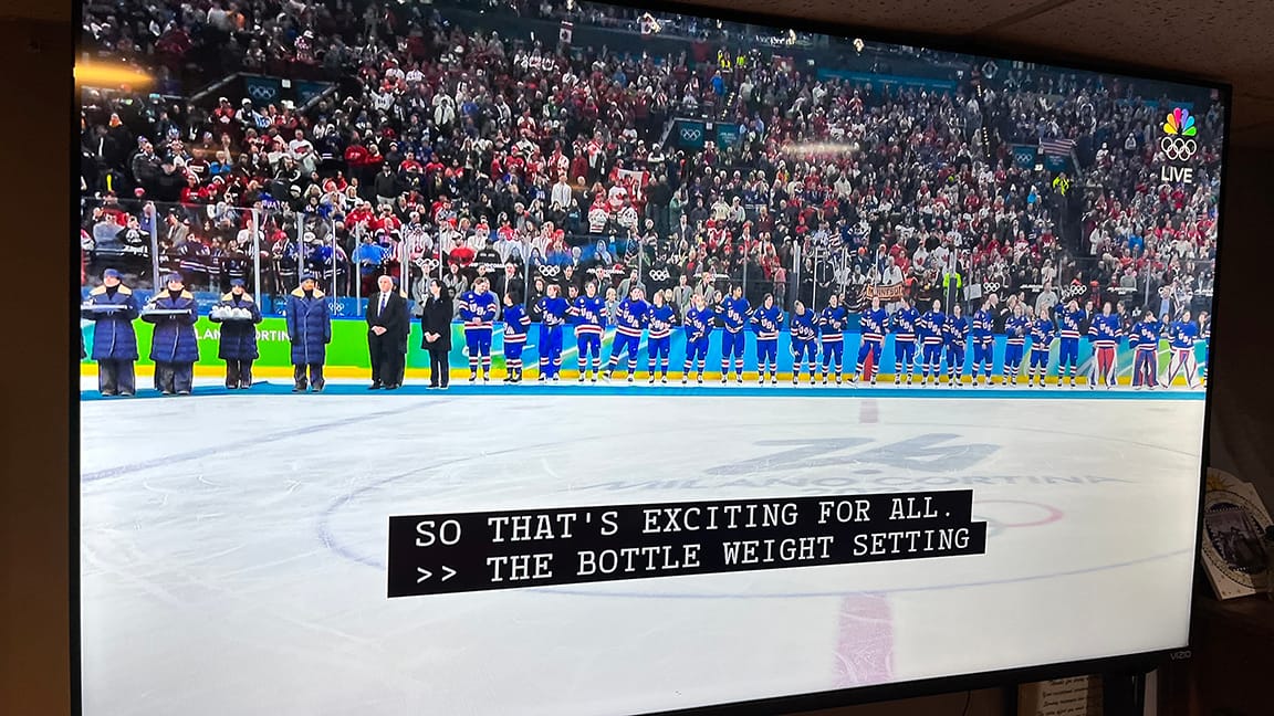A WHOLE BUNCH OF HOCKEY PLAYERS FROM TEAM USA LINED UP FOR A MEDAL