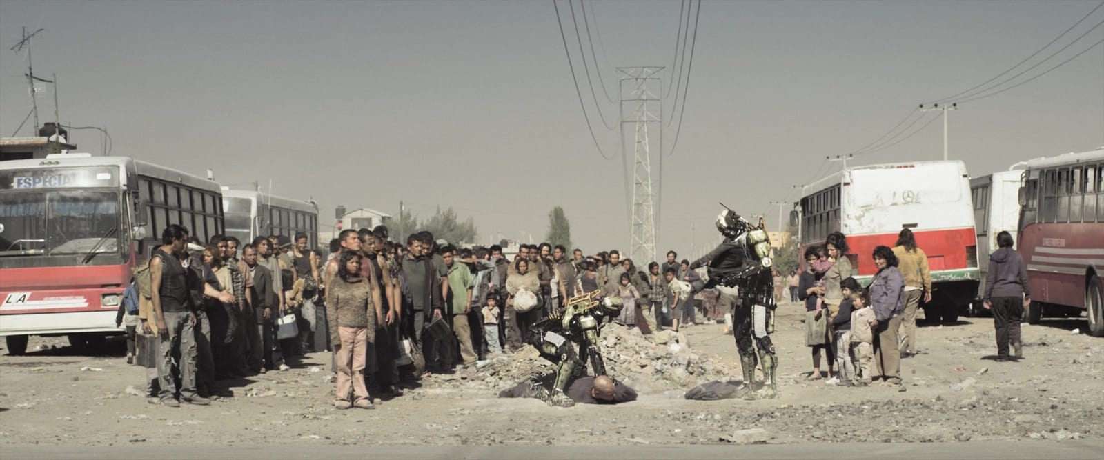 BLEAK NEAR-FUTURE LOS ANGELES DUSTY RUBBLE PEOPLE IN TATTERED CLOTHING LINED UP ROBOTS STANDING OVER MATT DAMON